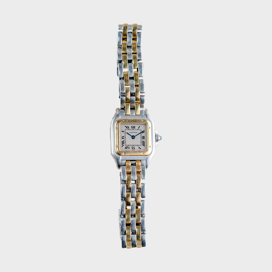Two-tone watch with a white face on a light gray background
