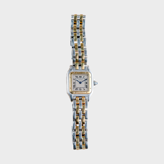 Two-tone watch with a white face on a light gray background