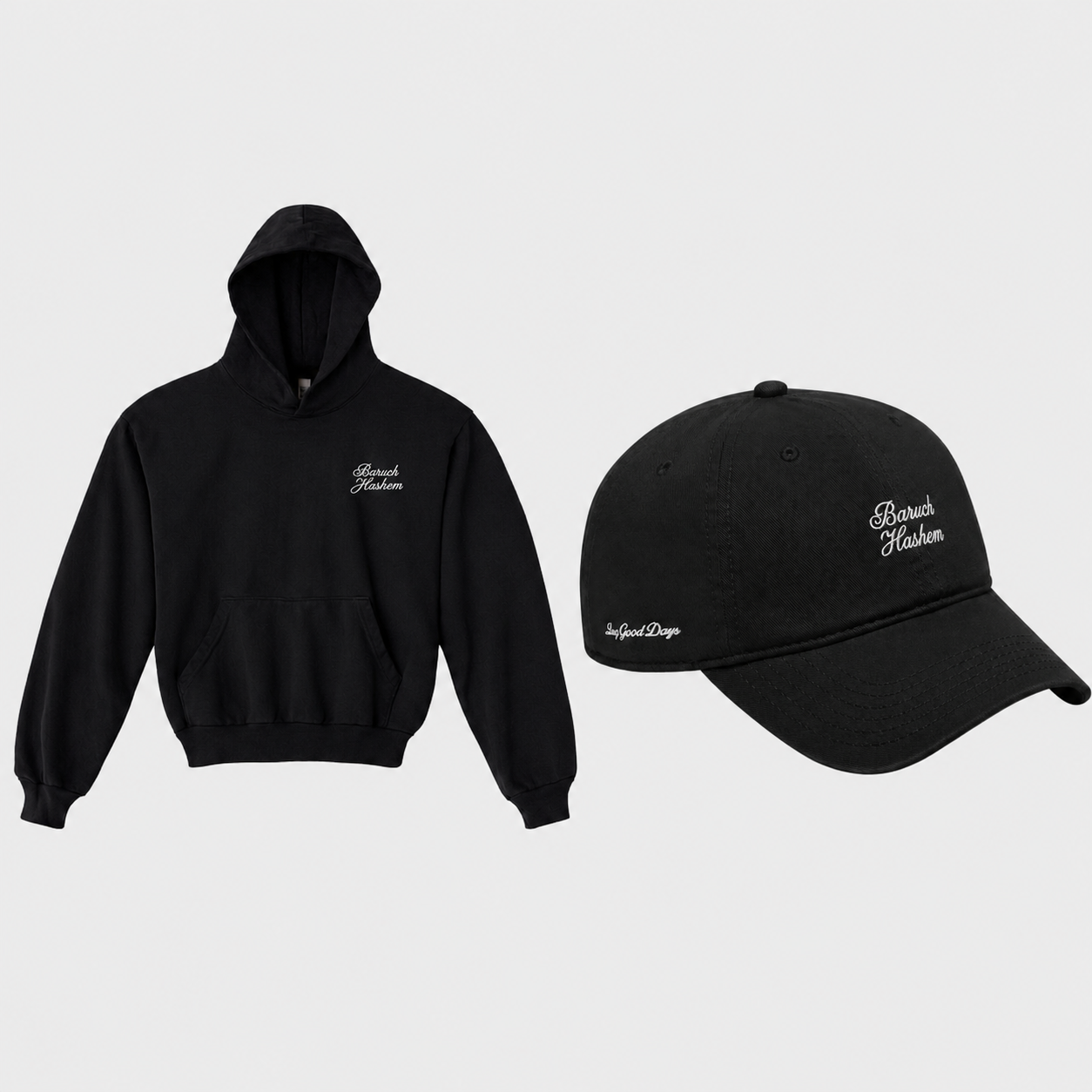A black hoodie and matching black baseball cap displayed side by side on a light gray background. Both items feature white embroidered baruch hashem script text on the front and side.