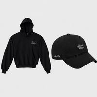 A black hoodie and matching black baseball cap displayed side by side on a light gray background. Both items feature white embroidered baruch hashem script text on the front and side.