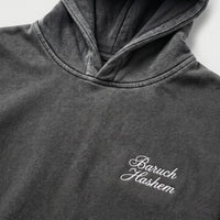 Vintage black hoodie with 'Baruch Hashem' embroidery on a light gray background