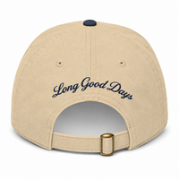 Beige cap with 'Long Good Days' text on a white background