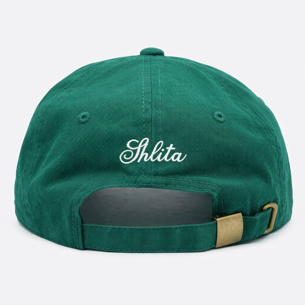 Green cap with 'Shlita' embroidered on the back against a white background