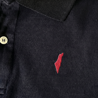 Black polo shirt with a small red israel logo on a white background