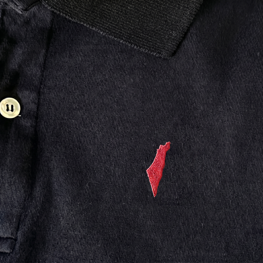 Black polo shirt with a small red israel logo on a white background