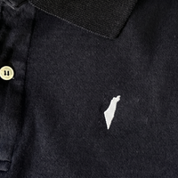 Black polo shirt with a small white israel logo on a white background