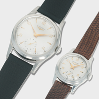 Two vintage longines watches with different strap colors on a light gray background