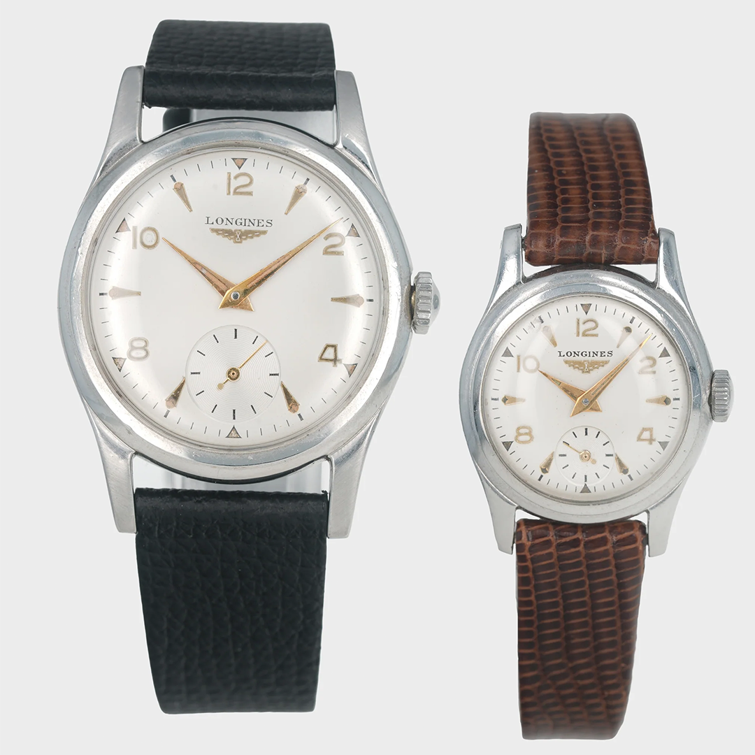 Two vintage Longines watches with black and brown leather straps on a light gray background