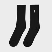 Pair of black socks with a small white logo on a light gray background