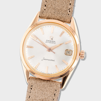 Vintage Rose gold Omega watch with beige leather strap on a light gray background