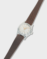 Vintage Longines Women's Wristwatch with brown strap and white dial on a light gray background